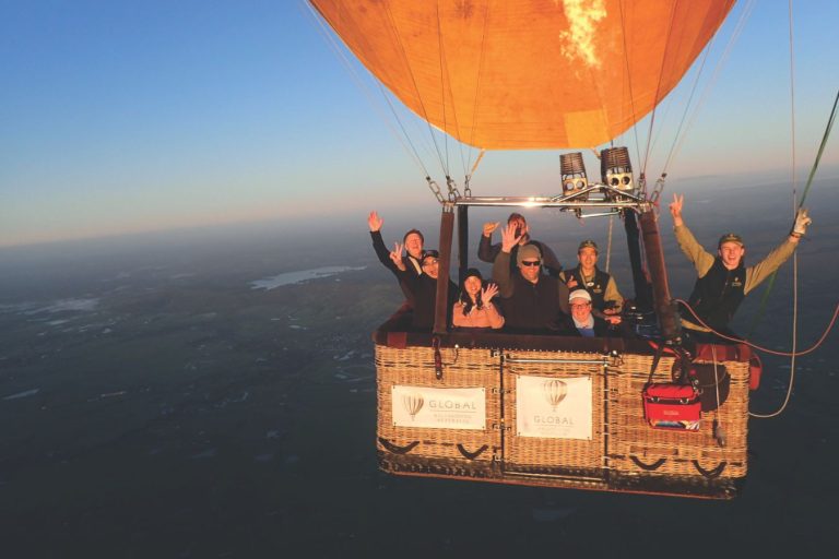 A Global Ballooning Australia group pictured mid-flight in the hot air balloon basket over the Yarra Valley