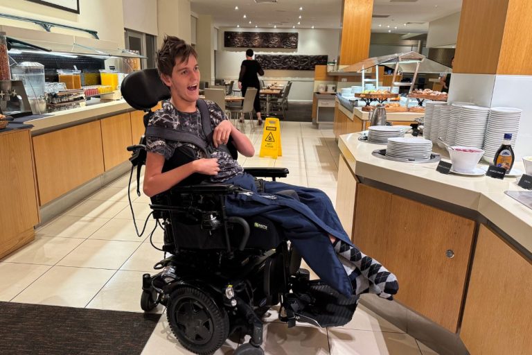 A young man in a wheelchair exploring the breakfast buffet at Rydges Rotorua