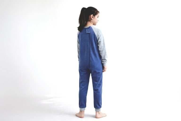 A young girl wearing the new Wonsie winter weight back zip bodysuit